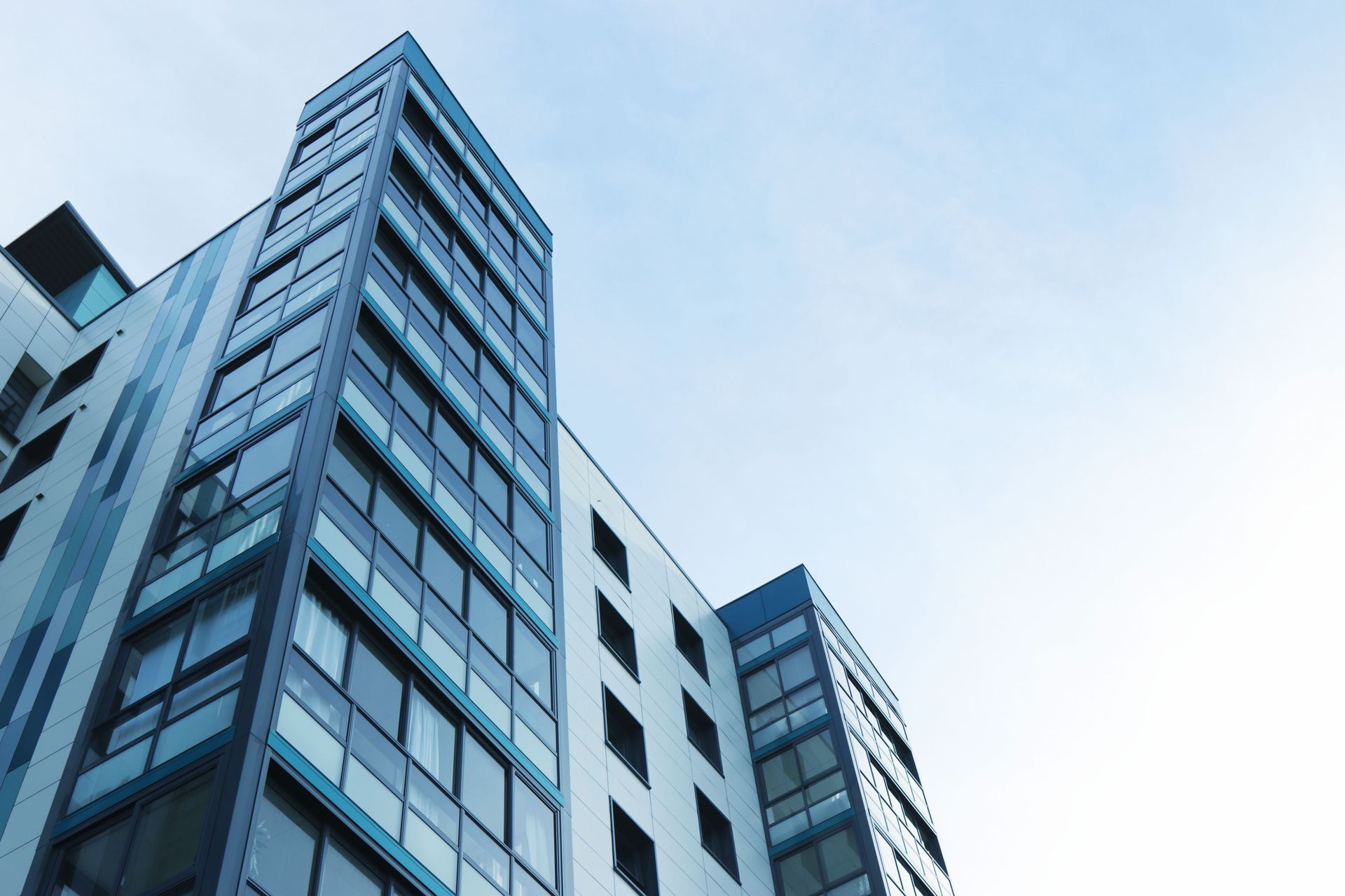 Glass office tower against a clear sky